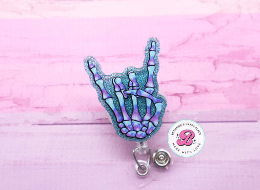 Rock on skeleton hand badge reel