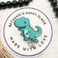 Teal dinosaur badge reel