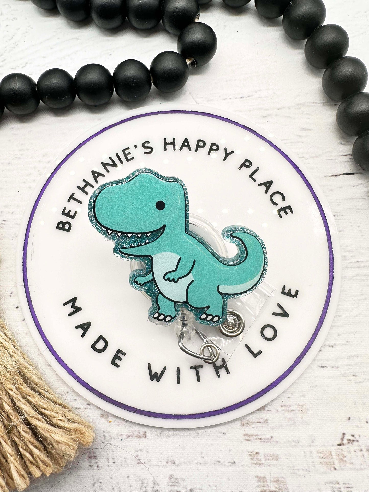 Teal dinosaur badge reel