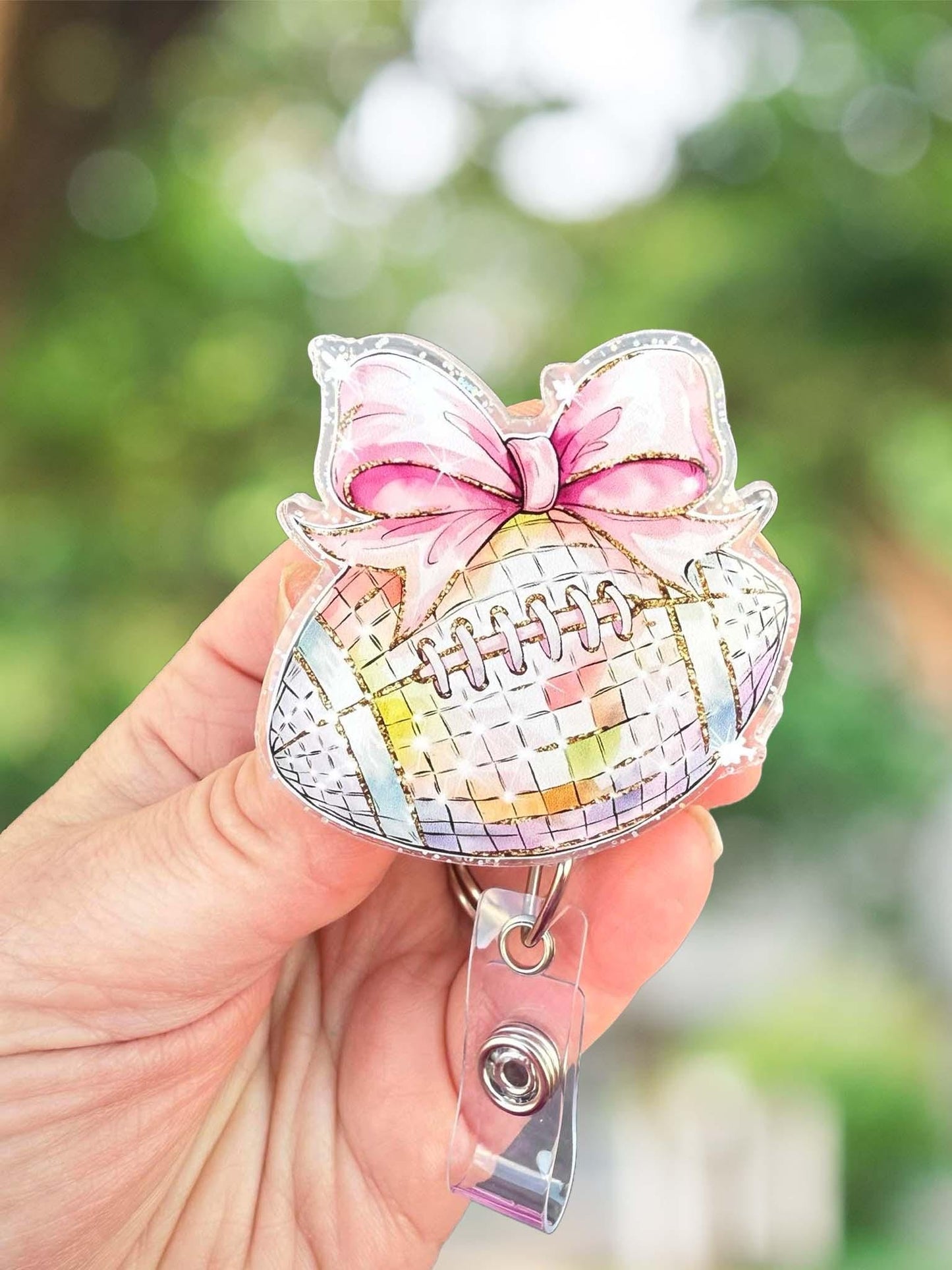 Disco football with bow retractable badge reel