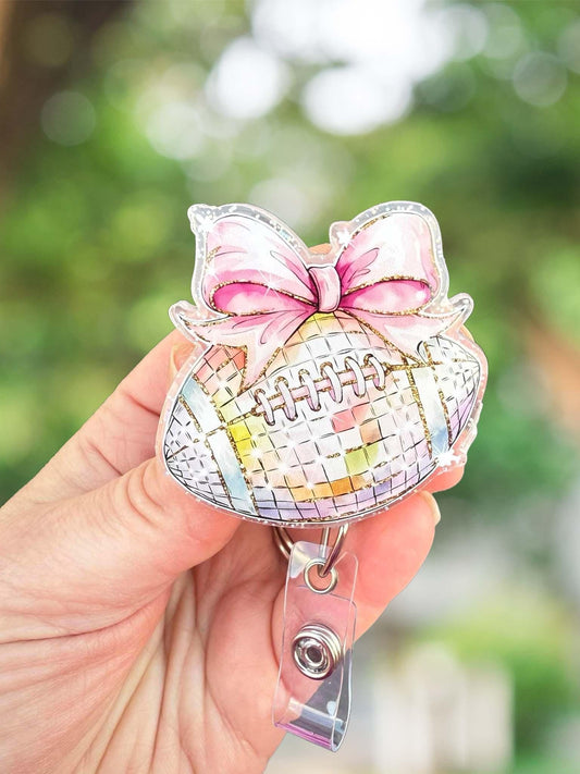 Disco football with bow retractable badge reel