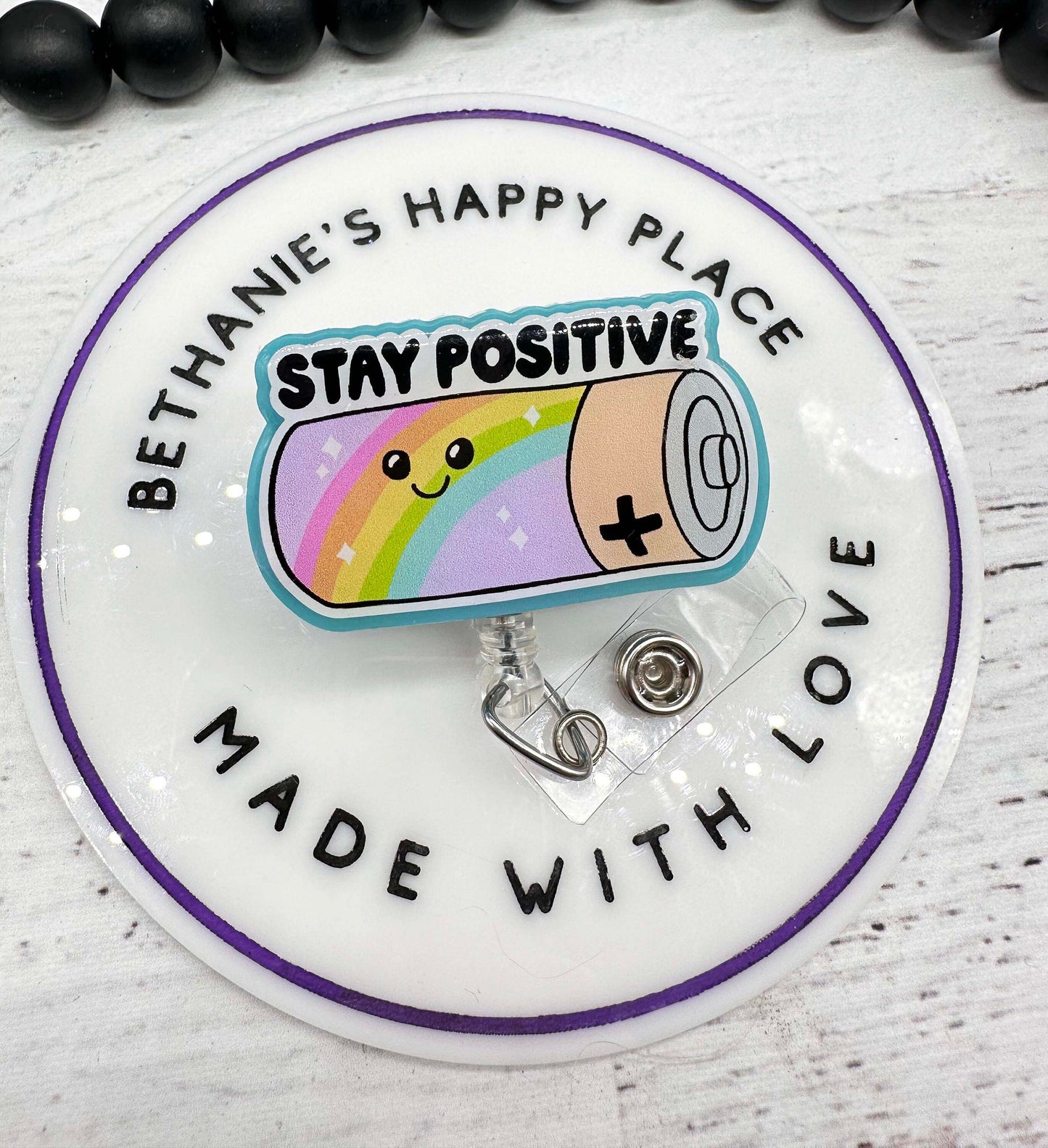 Stay positive battery badge reel