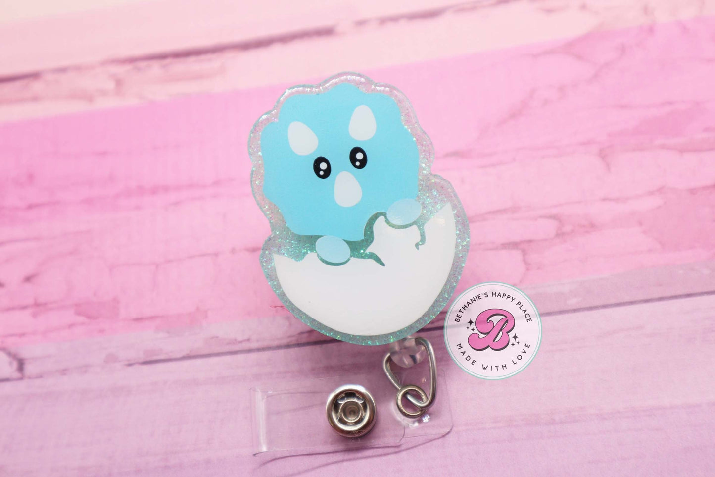Baby dinosaur badge reel