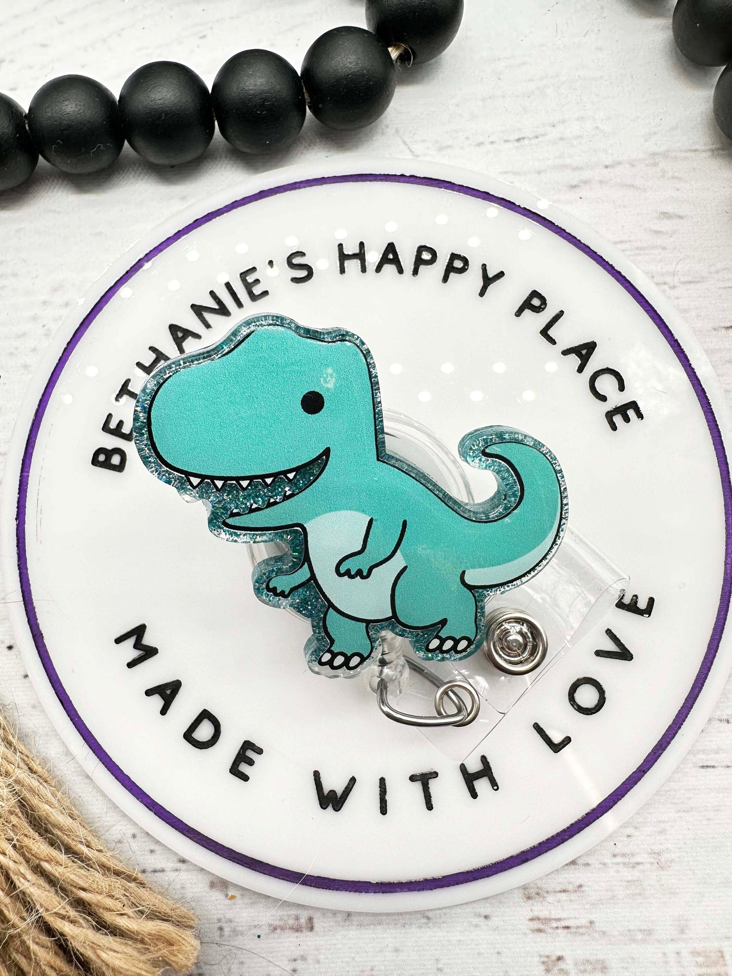 Teal dinosaur badge reel