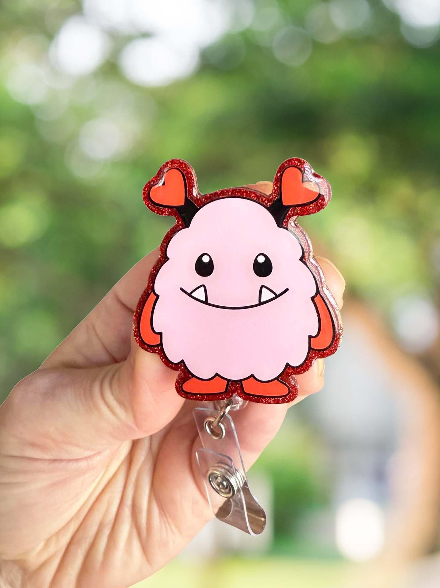 Pink and red monster retractable badge reel