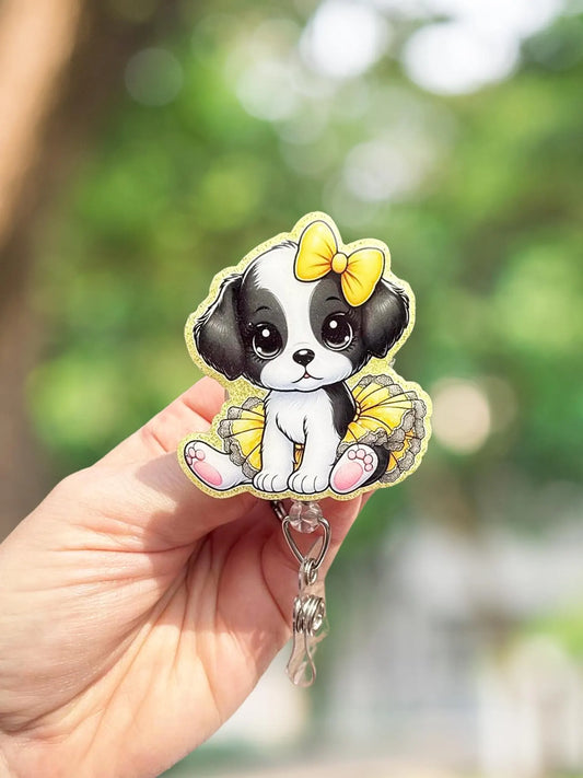 Cute puppy in yellow retractable badge reel